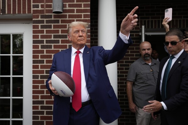 Trump stops at a fraternity house on his way to Iowa Iowa State